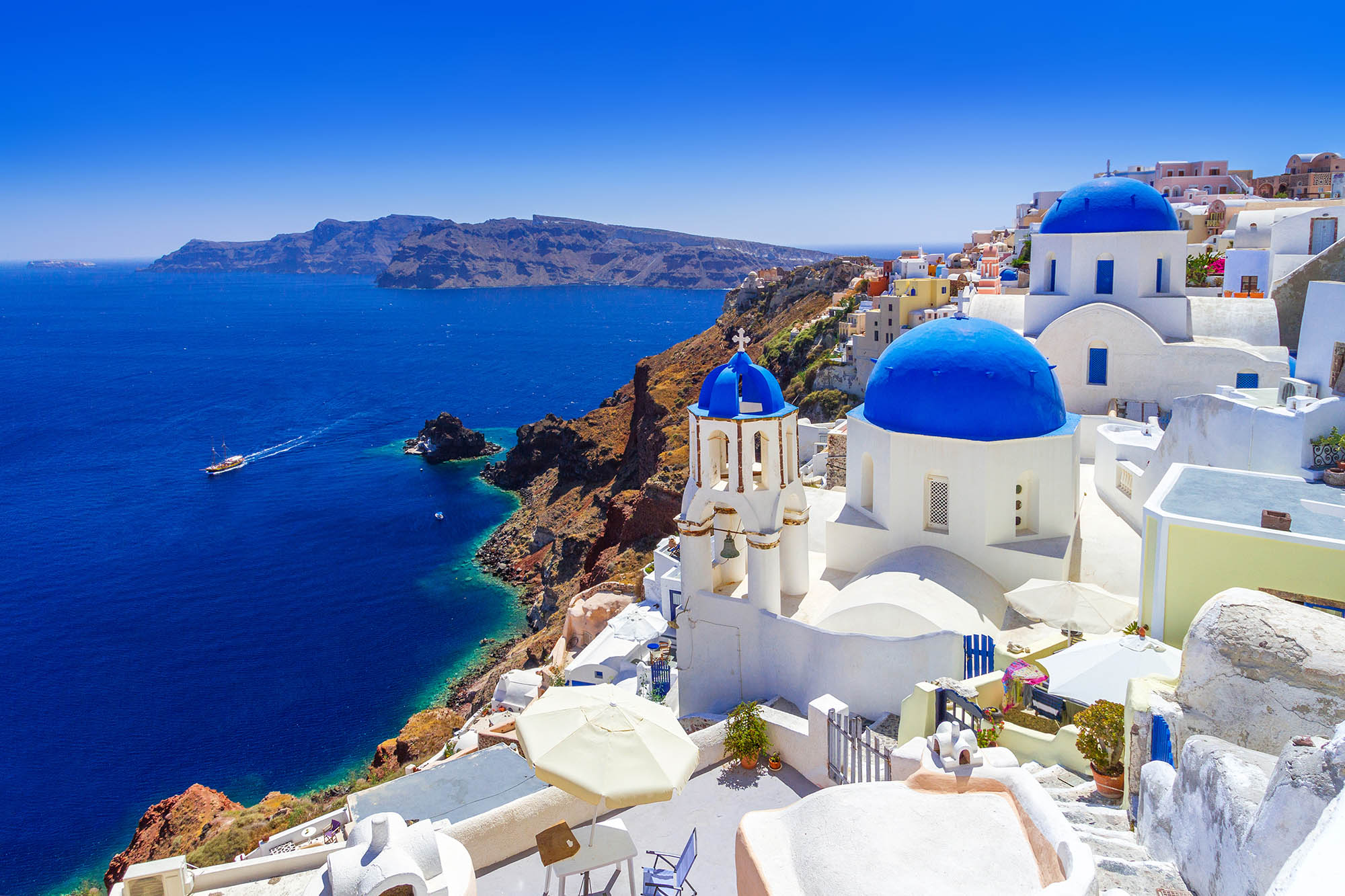 Santorini Greece with white buildings and blue domes overlooking the ocean